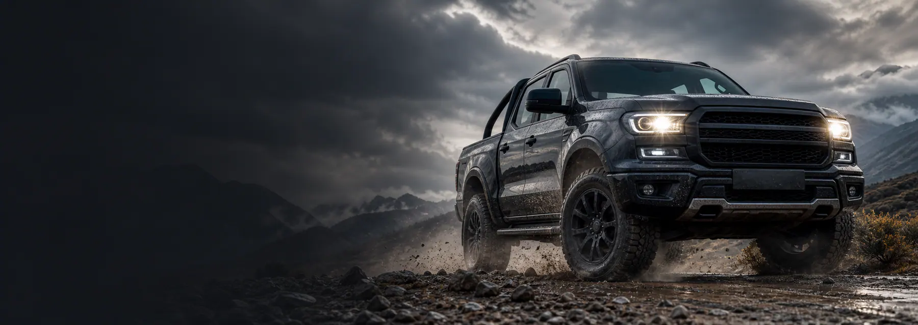 4WD ute driving on a rocky Australian road under storm clouds